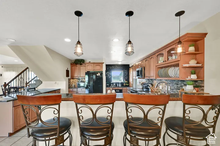 Kitchen island with three pendant lights and built-in cabinetry