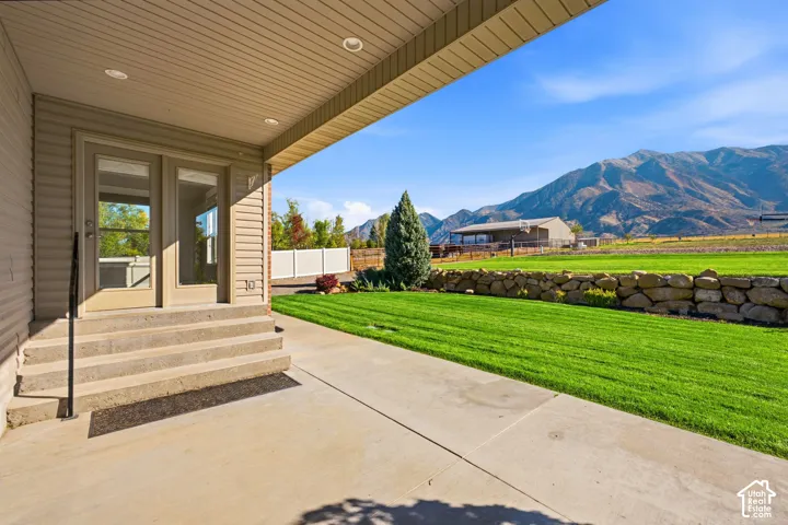 Covered patio with recessed lighting, concrete steps, and double glass-paneled doors