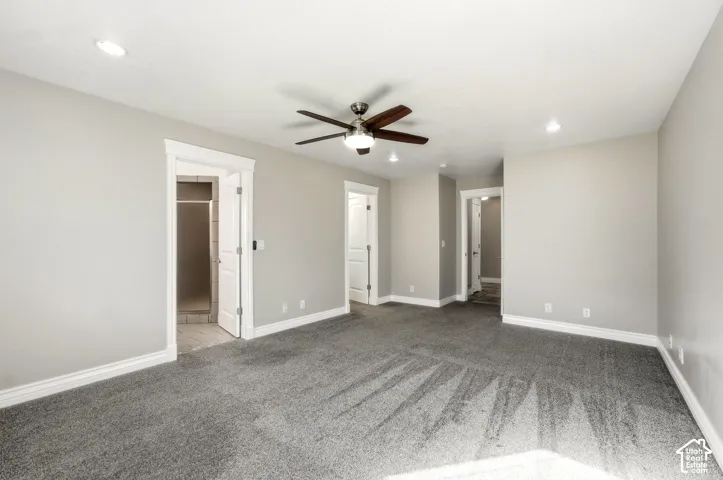 Spacious room with gray carpeting and light gray wall paint