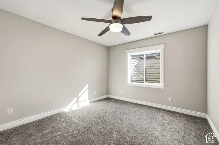 Recessed window with white trim, a ceiling fan with integrated lighting, and carpet flooring