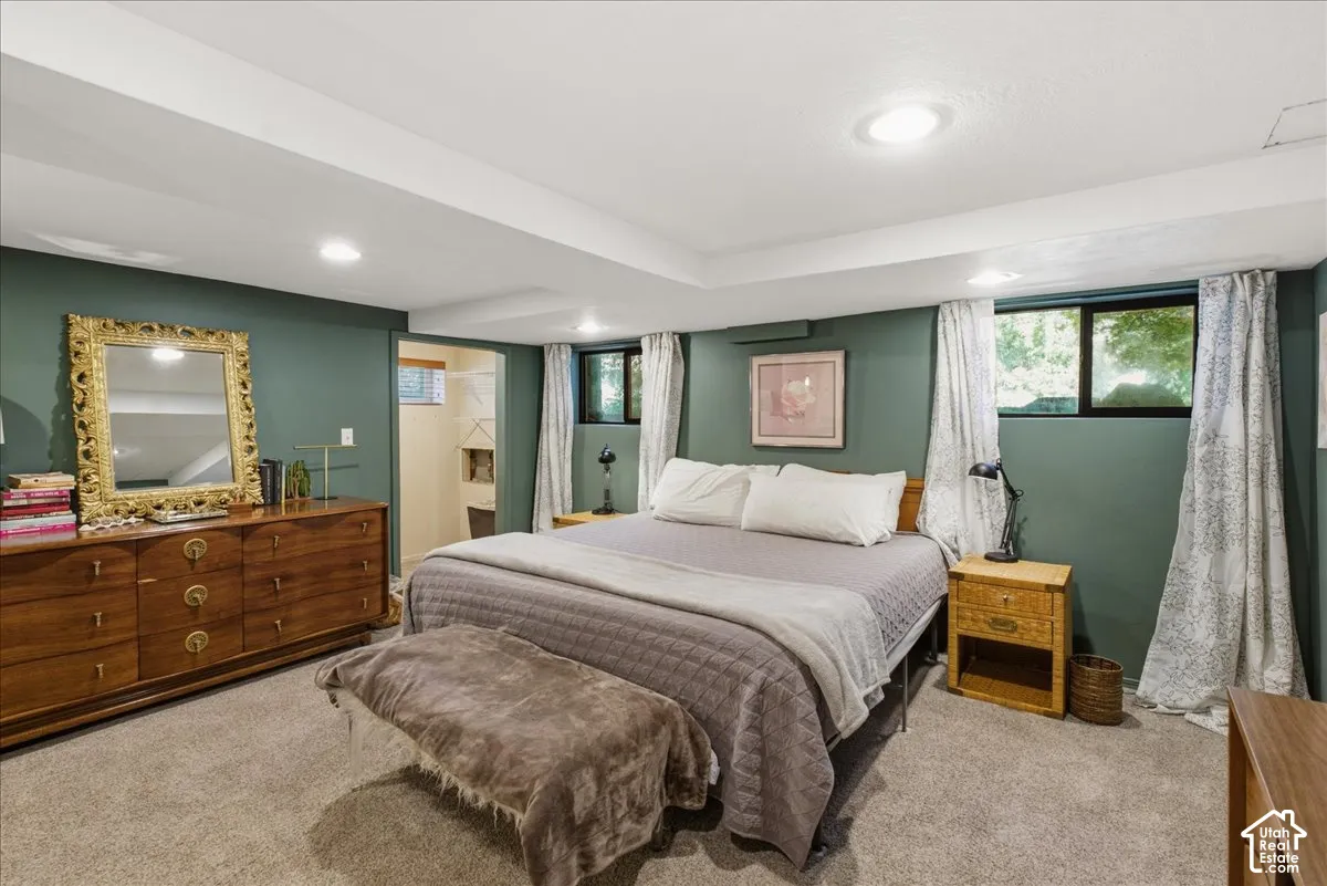 Recessed lighting, wood-finish dresser, and carpeted flooring