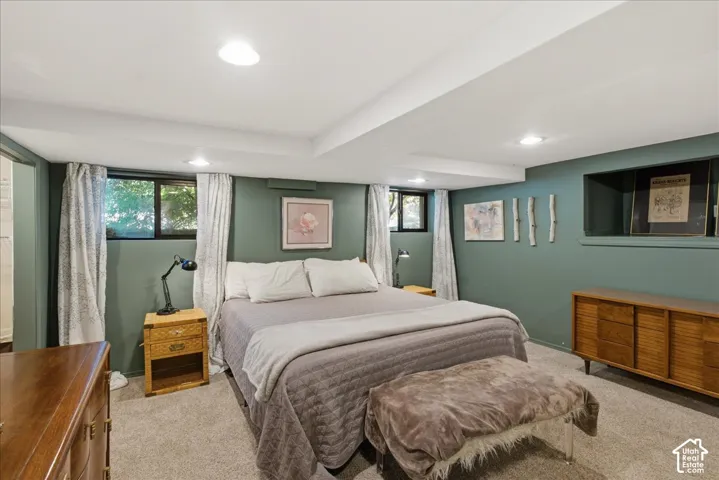 Recessed lighting, soft gray carpeting, and neutral-toned walls