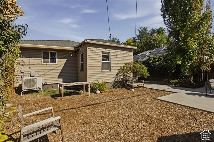 Tan siding exterior with a dark shingle roof