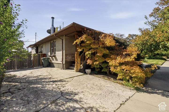 Siding exterior with brick accent, covered entry, and established landscaping
