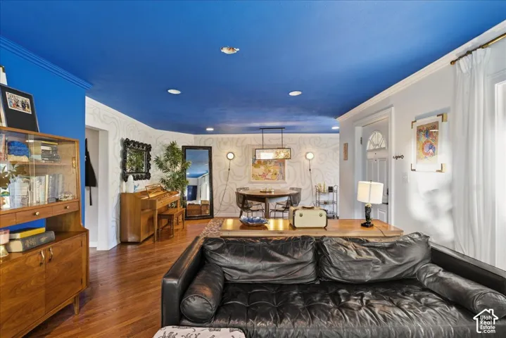Hardwood flooring throughout, recessed ceiling lighting, and crown molding
