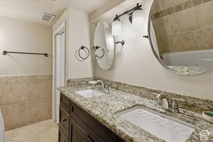 Dual undermount sinks with granite countertops and dark wood-finish vanity