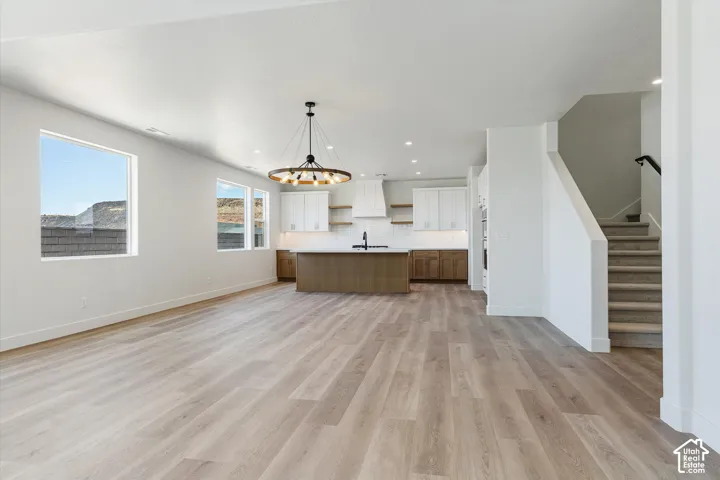Open-concept living space with light wood-finish flooring