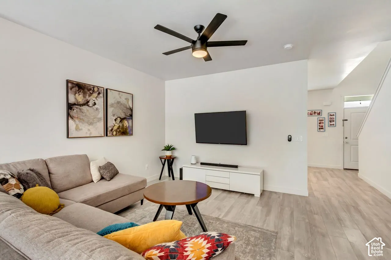 Recessed lighting, wood-finish flooring, and a modern ceiling fan with integrated lighting