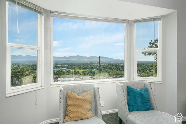 Bay window with multiple large panes, offering expansive scenery of mountains and distant urban landscape