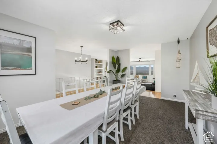 Recessed lighting, wood-finish flooring, built-in shelving, mountain scenery, and a ceiling fan
