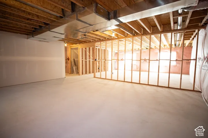 Unfinished basement with potential for large family/game room, a full bathroom and three bedrooms.