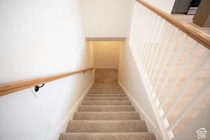 Fully-finished stairwell to unfinished basement.