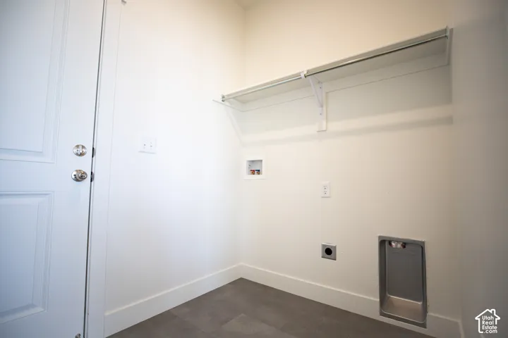 Full-size dedicated laundry room adjacent to garage and kitchen with washer/dryer hookups.