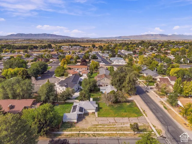 Residential neighborhood featuring mature trees and a distant mountain range