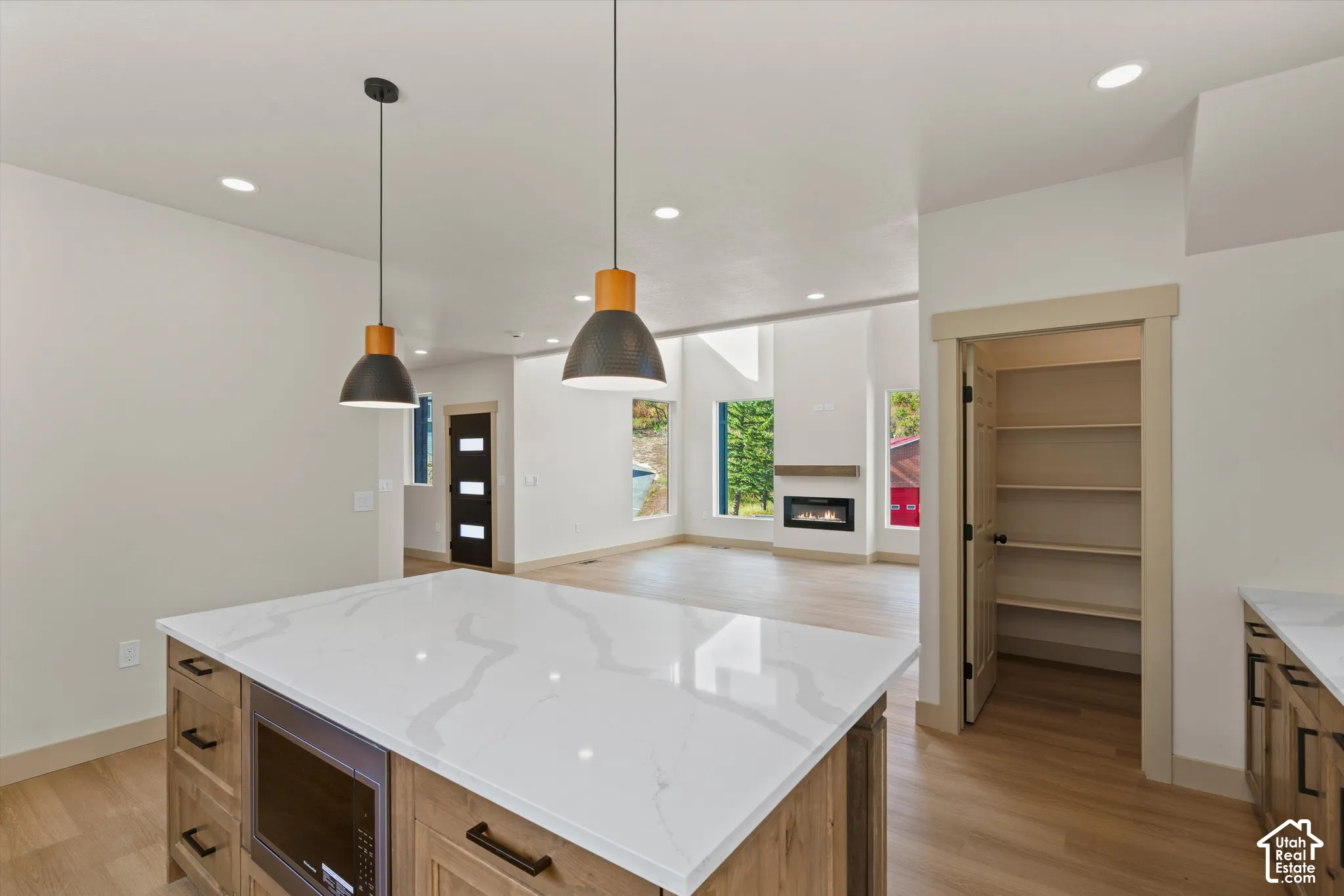 Kitchen island with a white countertop and integrated microwave