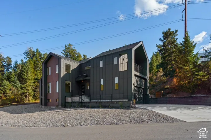 north west side of house. front of house. Modern architectural exterior featuring contrasting dark paneling and a light wood-finish accent