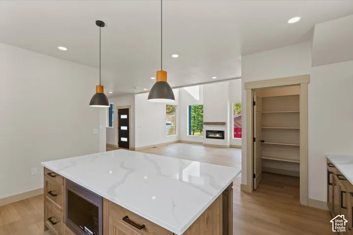Kitchen island with a white countertop and integrated microwave