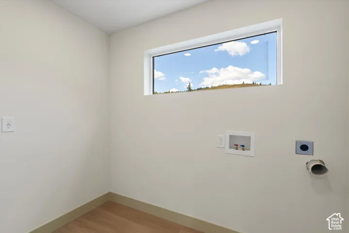 Upper fixed window, light wood-finish flooring, washer hook-ups, dryer vent, electrical outlets