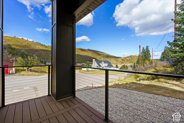 Outdoor decking with cable railing, surrounded by a natural landscape
