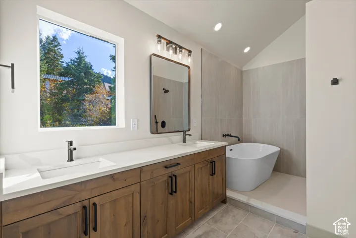 Primary Bathroom Double vanity with undermount sinks and wood-finish cabinetry