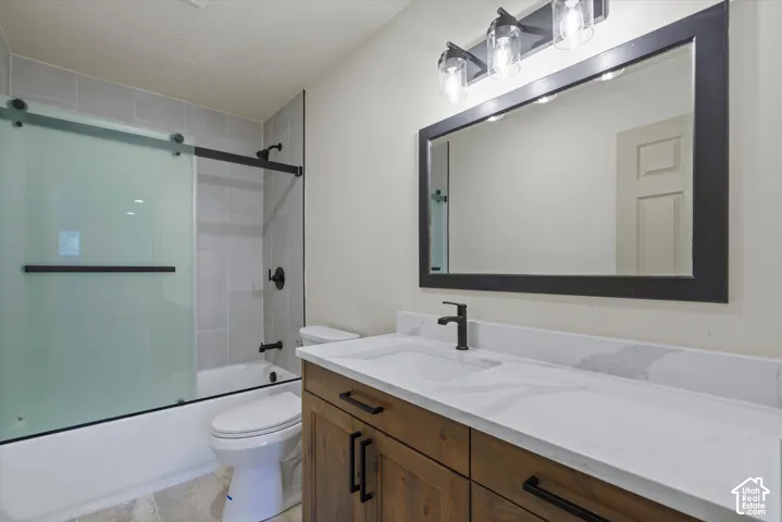 Wood-finish vanity with a white countertop and integrated sink