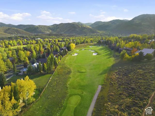 Expansive golf course frontage with manicured greens and sand bunkers