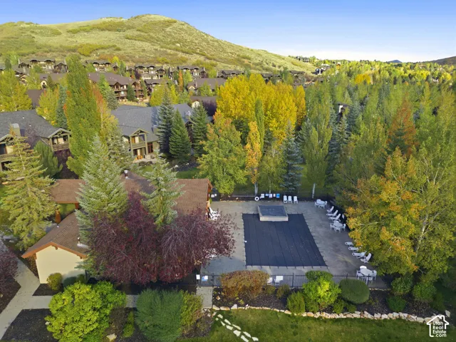 Outdoor leisure area featuring a covered pool, hot tub, and surrounding lounge seating