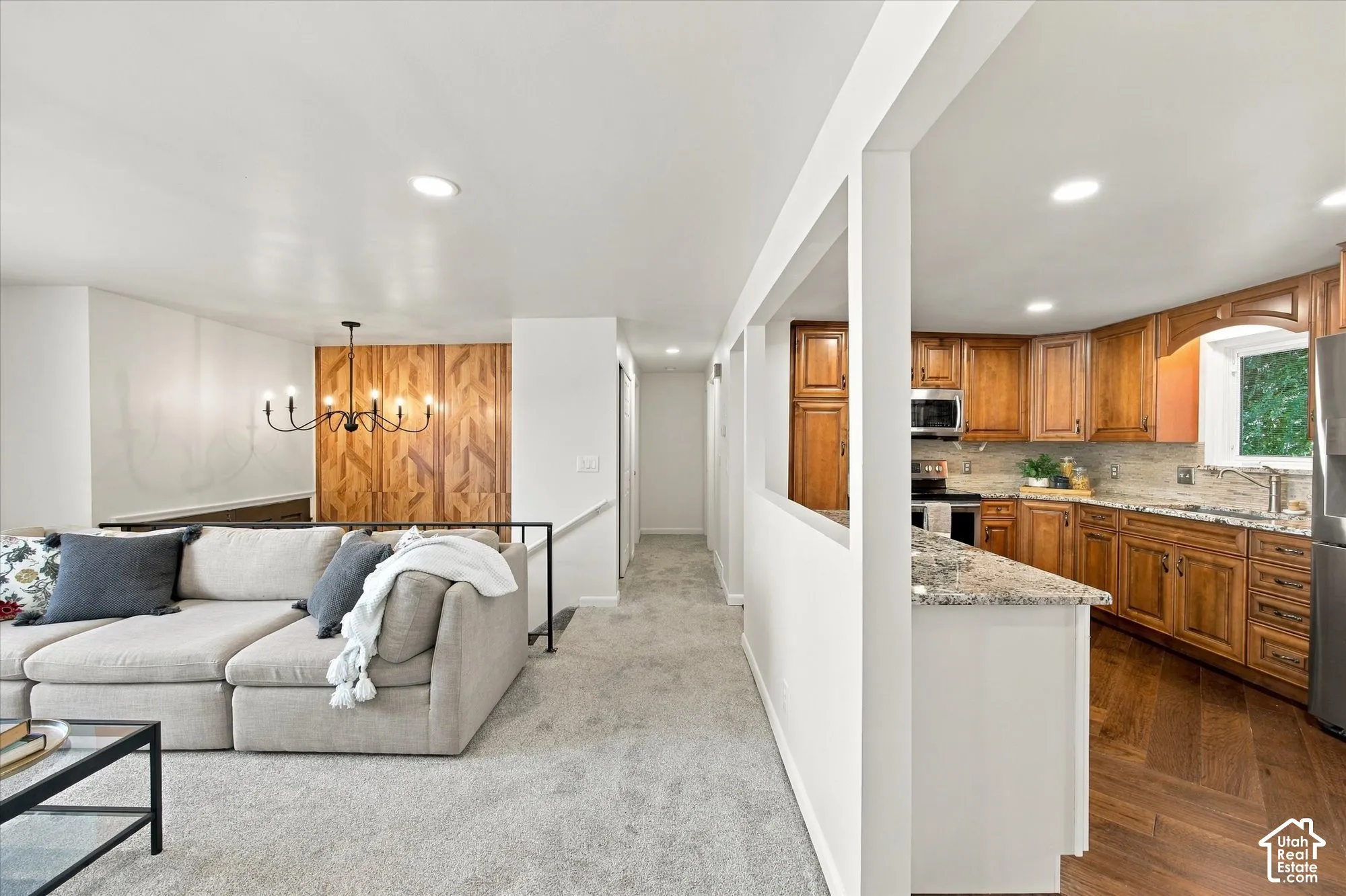 Kitchen featuring wood-finish flooring, granite countertops, and wood cabinetry