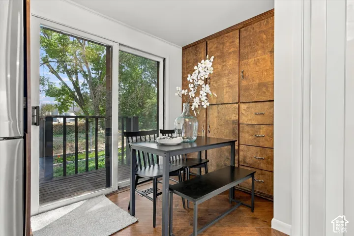Built-in cabinetry with varied storage, wood-finish flooring, and sliding glass door with balcony access