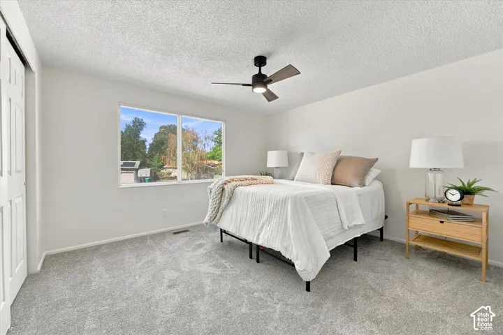 Wall-to-wall carpeting, dual pane windows, and a ceiling fan with integrated lighting