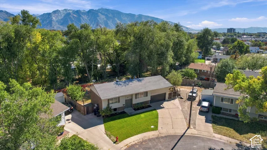 Single-family residence with an attached two-car garage, concrete driveway, and a manicured front lawn