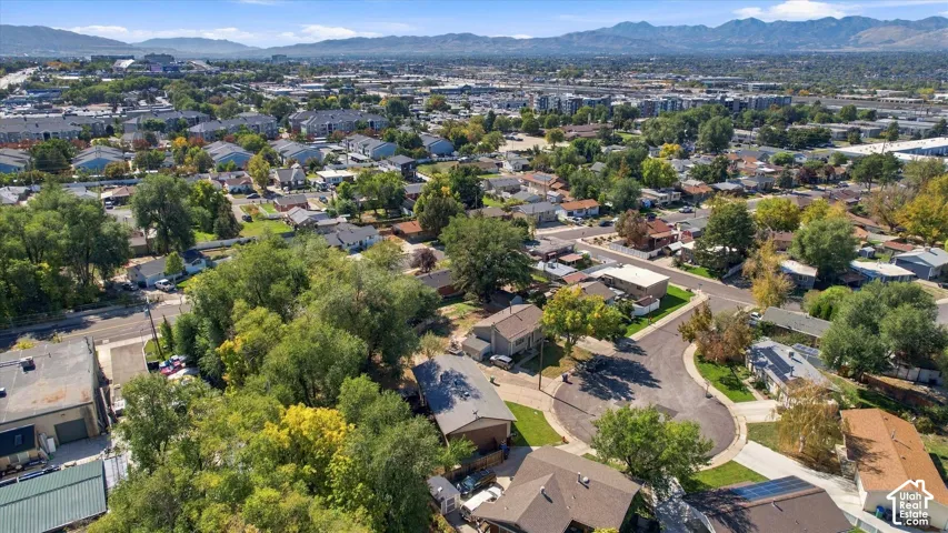 Aerial perspective of a developed neighborhood with residential properties and abundant mature trees