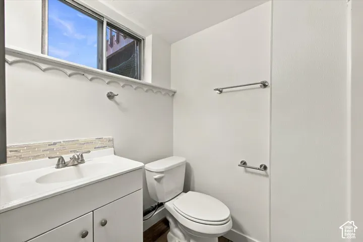 White vanity with brushed nickel hardware, undermount sink, and brushed nickel faucet