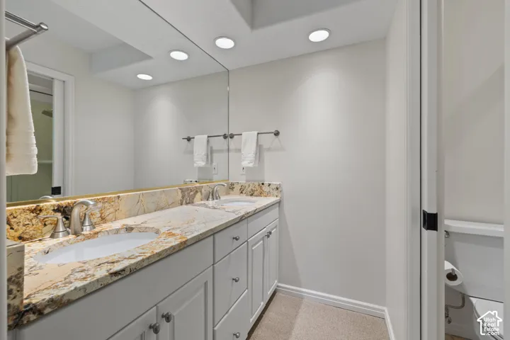 Dual vanity with stone countertops and undermount sinks
