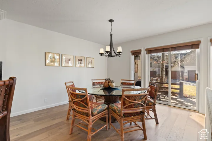 Wood-finish flooring, recessed lighting, and a glass-top round table