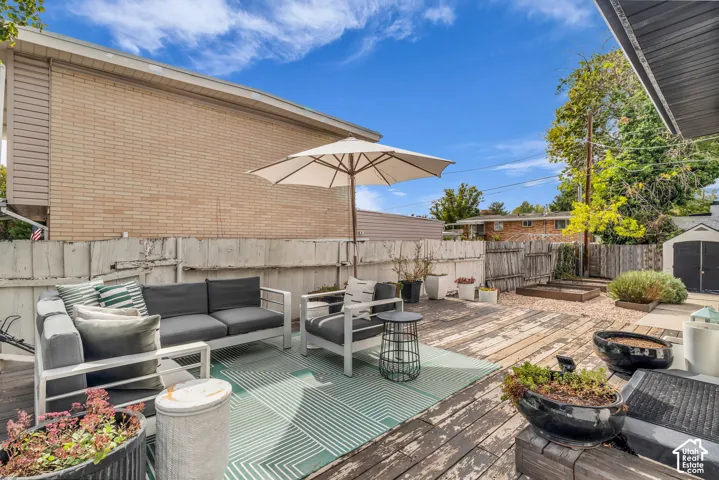 Expansive wooden deck area with a gravel section, raised garden beds, and perimeter fencing