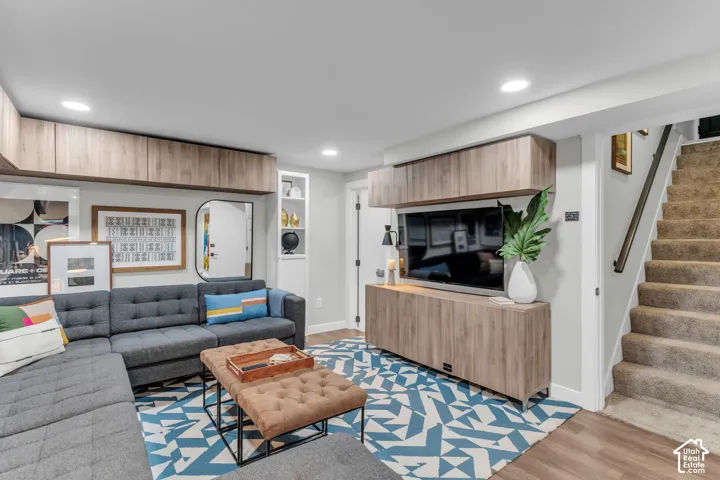 Built-in wood-finish cabinetry, recessed ceiling lighting, and a built-in wall niche with shelving