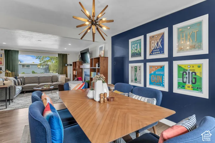 Wood-finish flooring throughout, a modern sputnik chandelier, and a wide window offering exterior views