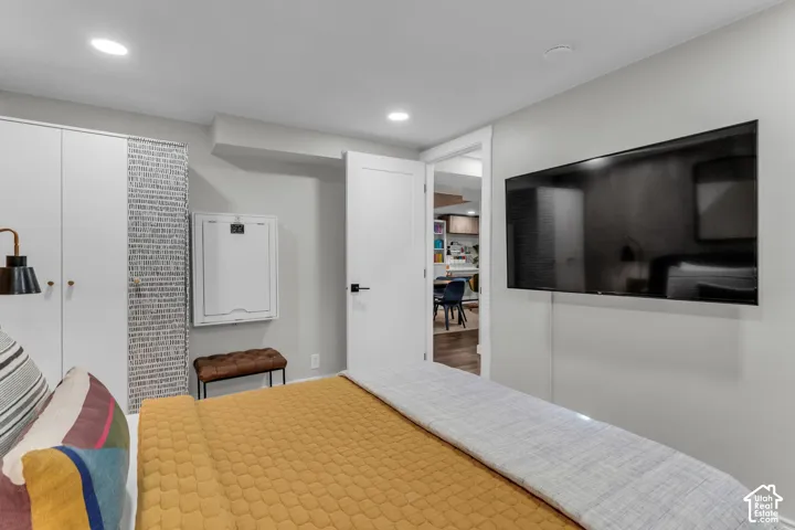 Recessed lighting, built-in cabinetry, and a wall-mounted flat-screen television