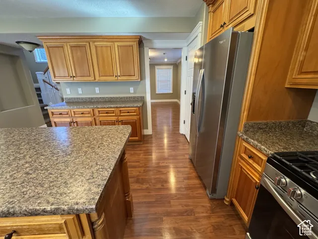 Wood-finish flooring throughout, complemented by wood cabinetry and stone-finish countertops