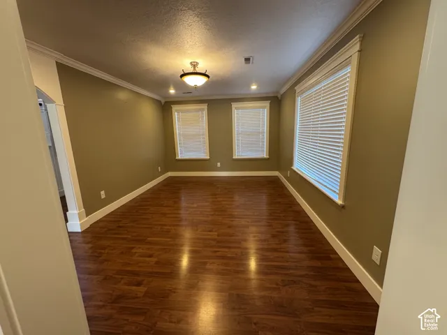 Wood-finish flooring throughout, complemented by crown molding and recessed lighting
