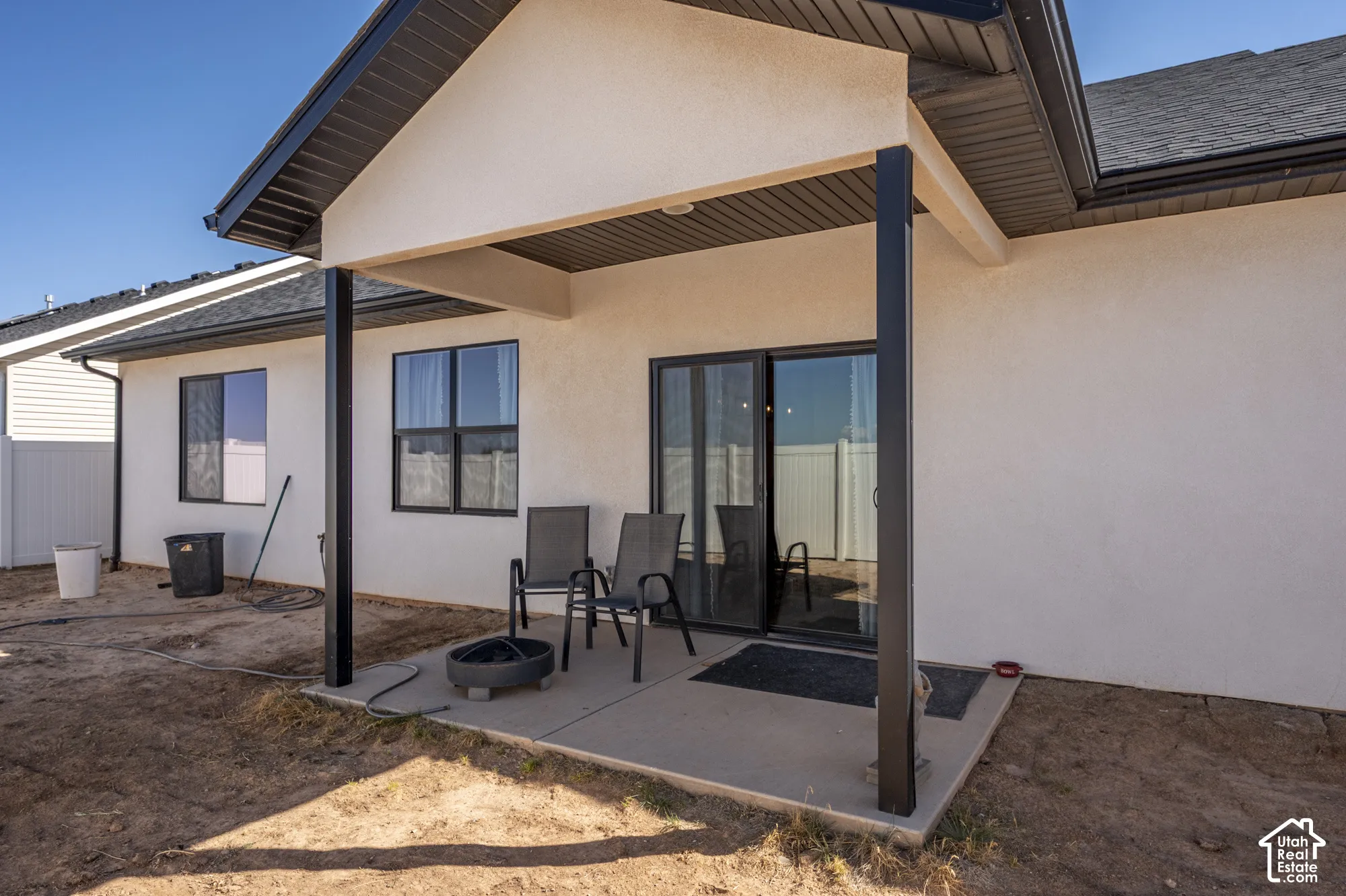 Covered patio featuring a concrete slab and black support columns