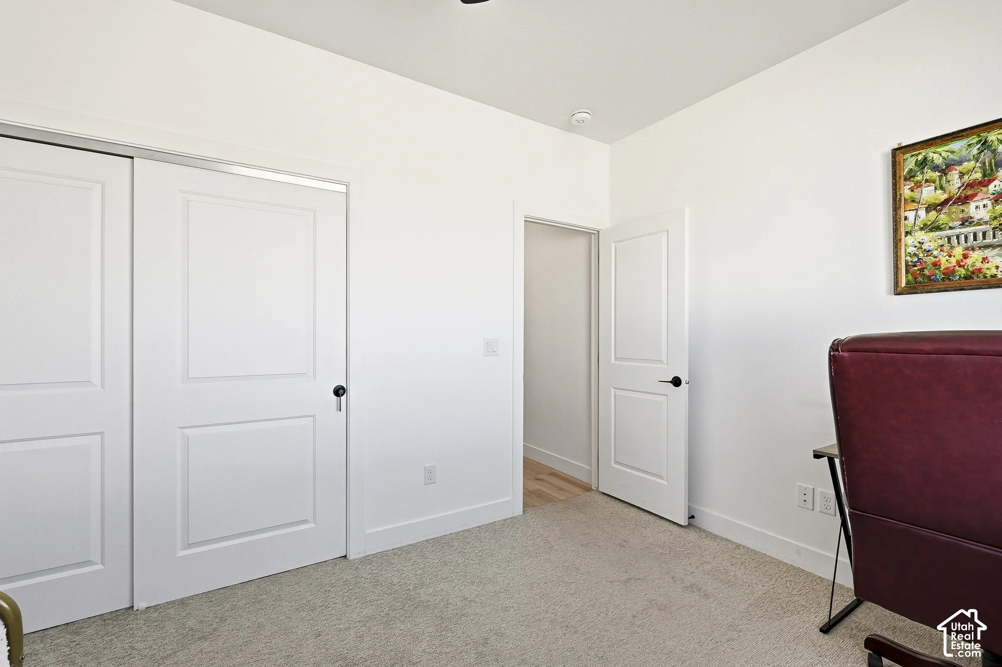 Light-toned carpeting, white walls, white two-panel doors, and recessed lighting