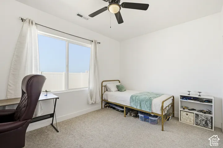 Recessed lighting, wall-to-wall carpeting, and a ceiling fan with integrated lighting