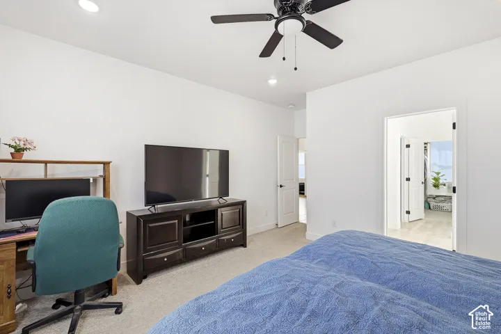 Recessed lighting, ceiling fan, and light-toned carpeting