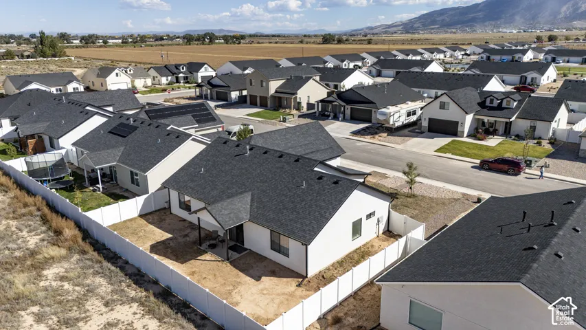 Residential neighborhood featuring a paved street, established homes, and undeveloped lots