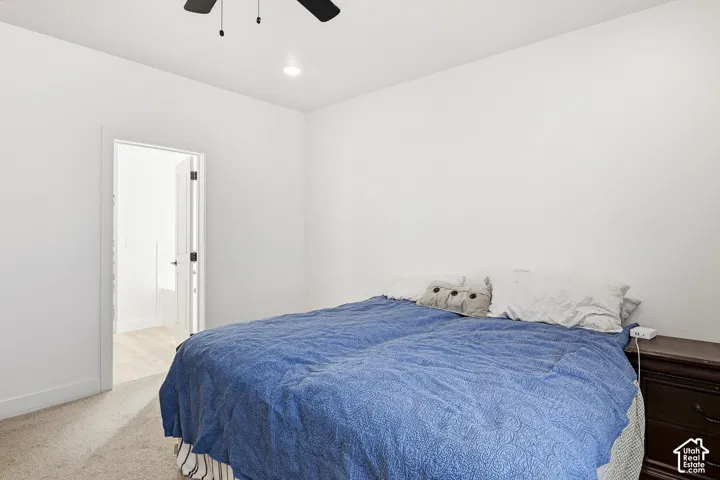 White walls, recessed ceiling lighting, and carpeted flooring