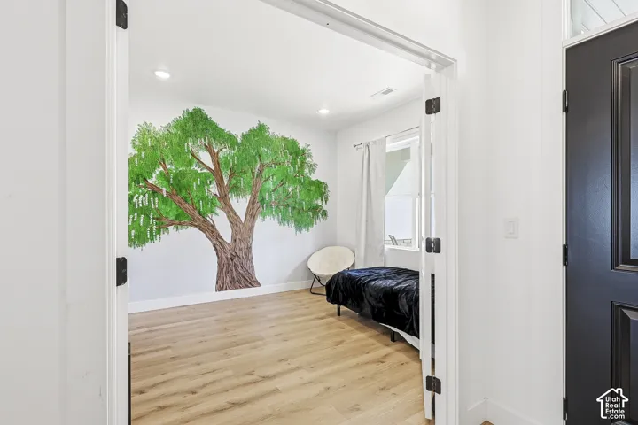 Wood-finish flooring, recessed lighting, and a window for natural light