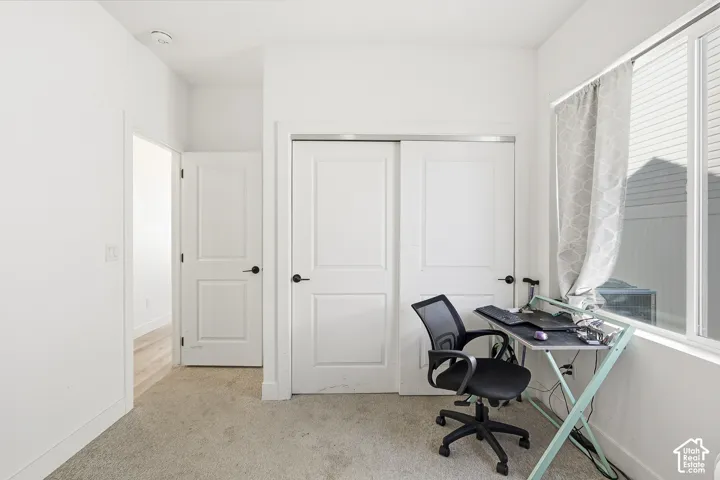 Room featuring neutral tone carpeting and a window with blinds