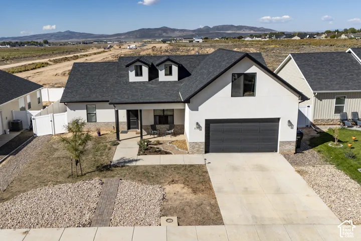 Contemporary exterior featuring white stucco and stone veneer accents